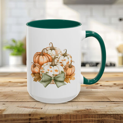 White 15oz ceramic mug with green interior/handle, featuring a watercolor autumn pumpkin bouquet and bow design.