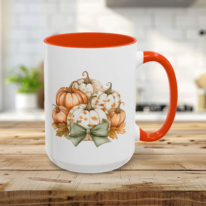 White 15oz ceramic mug with orange interior/handle, featuring a watercolor autumn pumpkin bouquet and green bow.