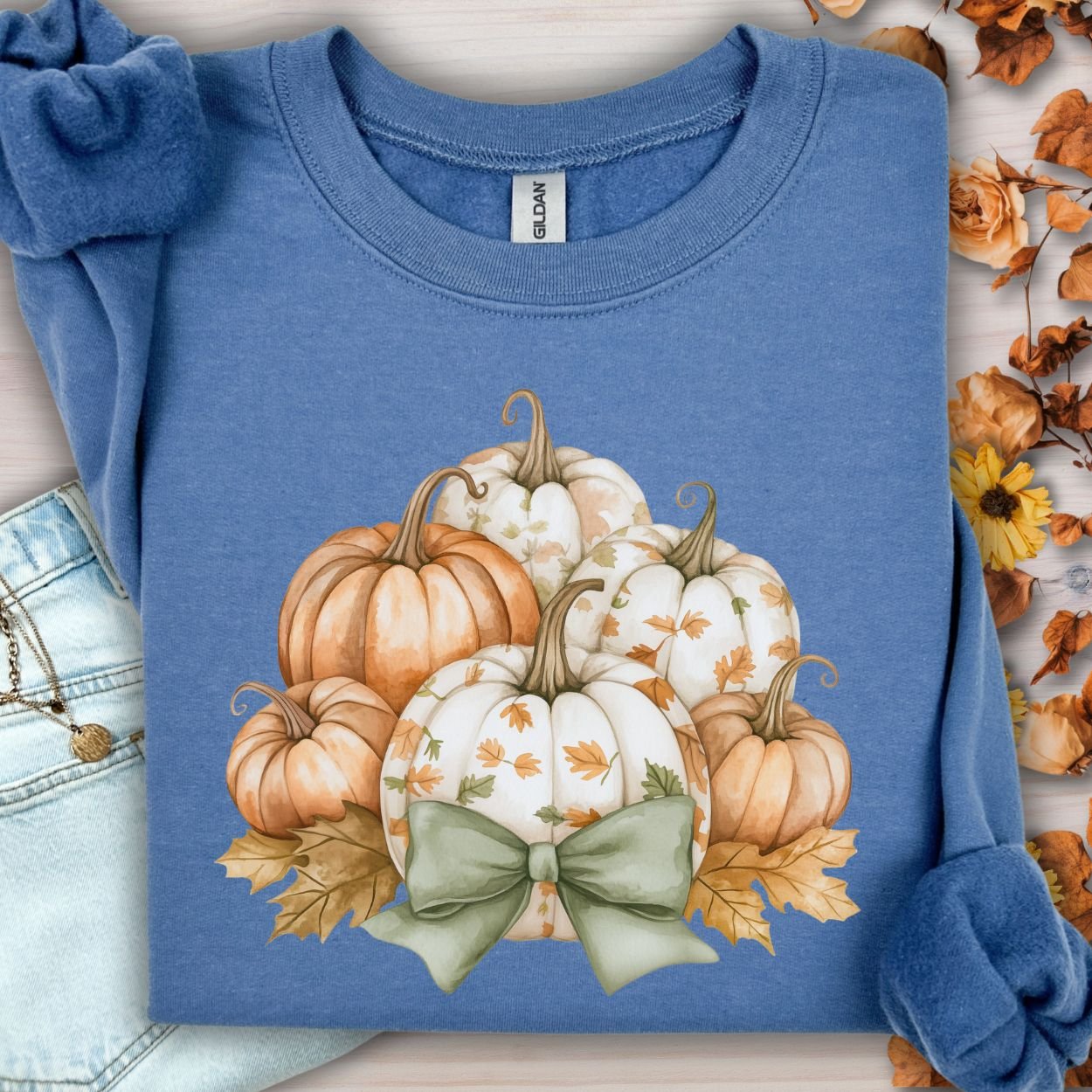 Indigo blue Gildan cotton-poly blend sweatshirt with a cottagecore pumpkin and green bow design.