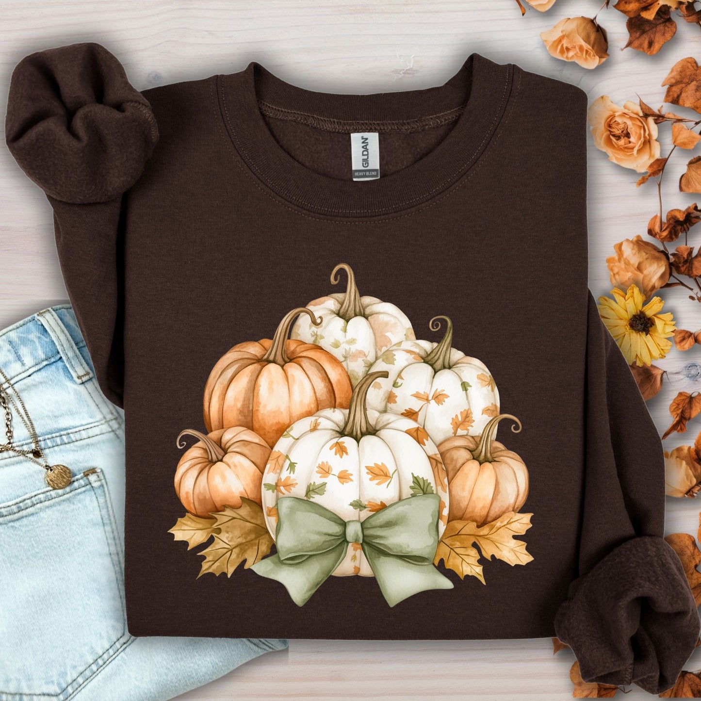 Dark chocolate Gildan sweatshirt with cottagecore pumpkins, green bow, and autumn leaves.