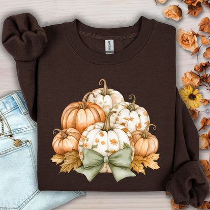 Dark chocolate Gildan sweatshirt with cottagecore pumpkins, green bow, and autumn leaves.