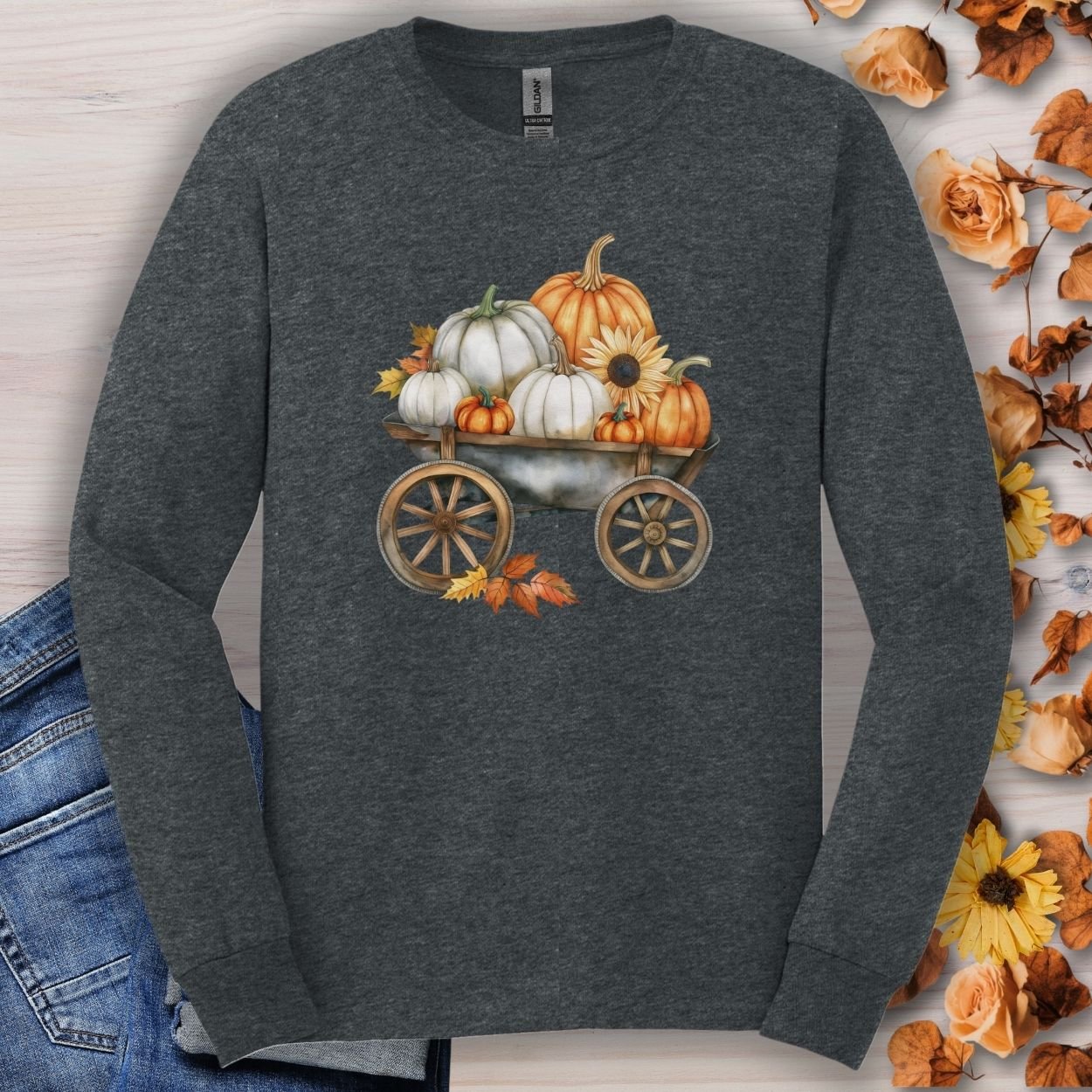 Dark Heather long sleeve tee with a watercolor wagon of white and orange pumpkins and fall leaves.