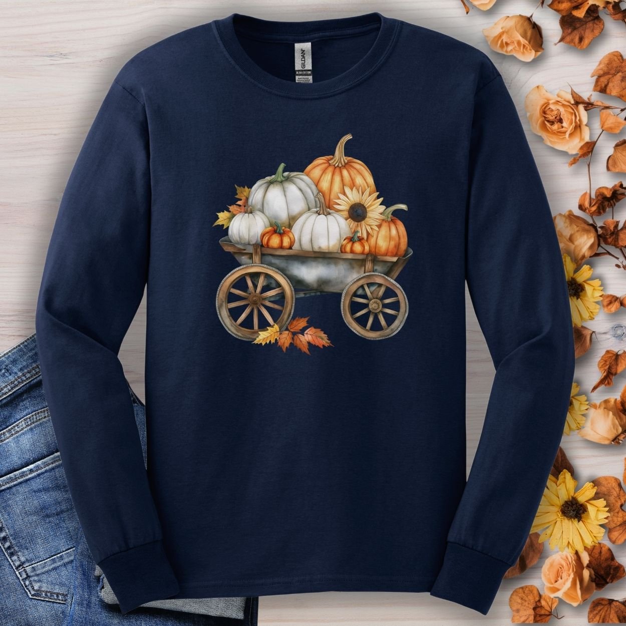 Navy long sleeve tee with a watercolor wagon of white and orange pumpkins, sunflowers, and fall leaves.