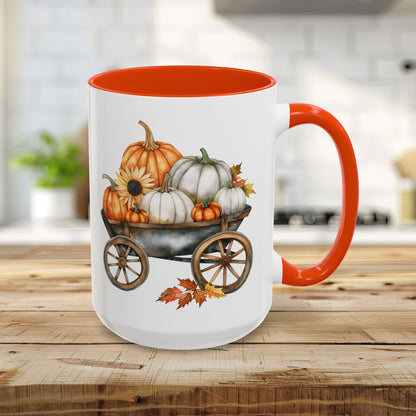 15oz ceramic mug with an orange interior and handle, featuring a watercolor-style autumn pumpkin harvest wagon design.