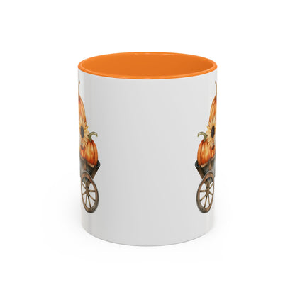 White ceramic mug with an orange interior and handle, featuring a watercolor-style autumn pumpkin wagon design.