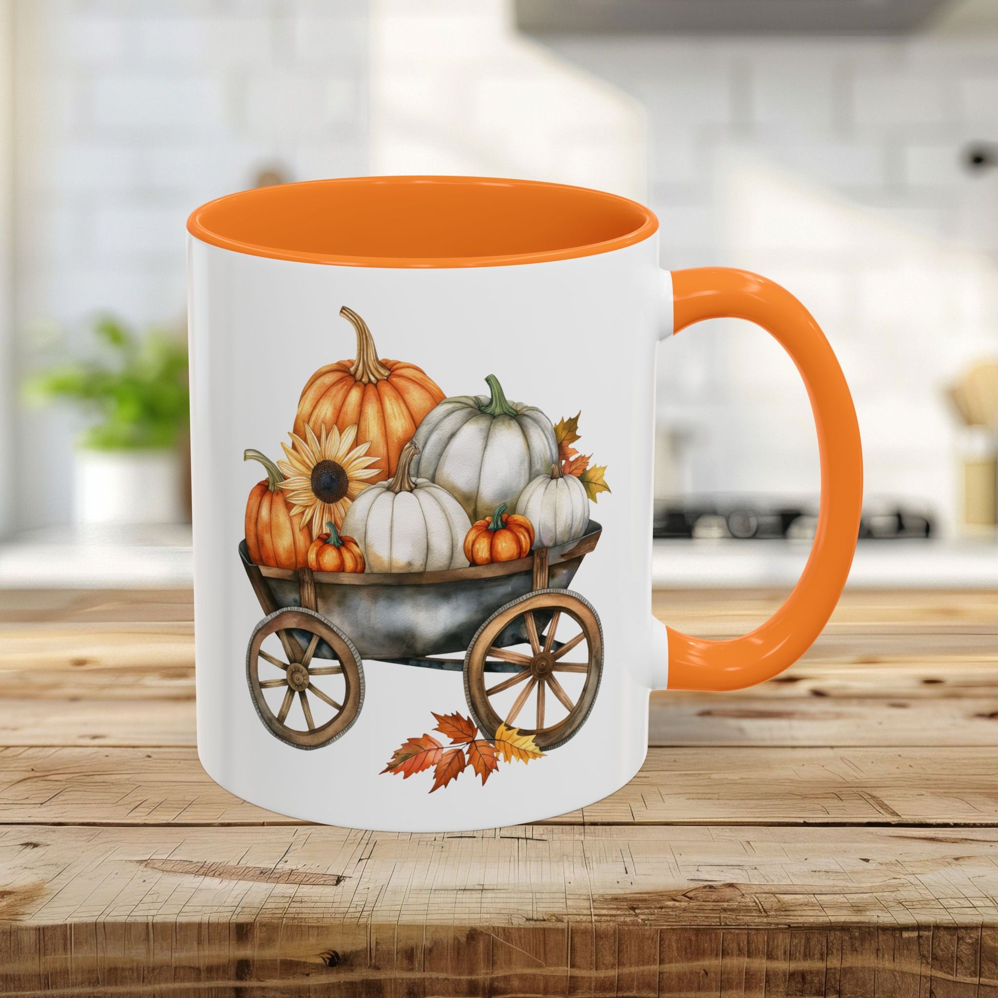 White ceramic mug with an orange rim and handle, featuring a watercolor-style autumn pumpkin harvest wagon design.