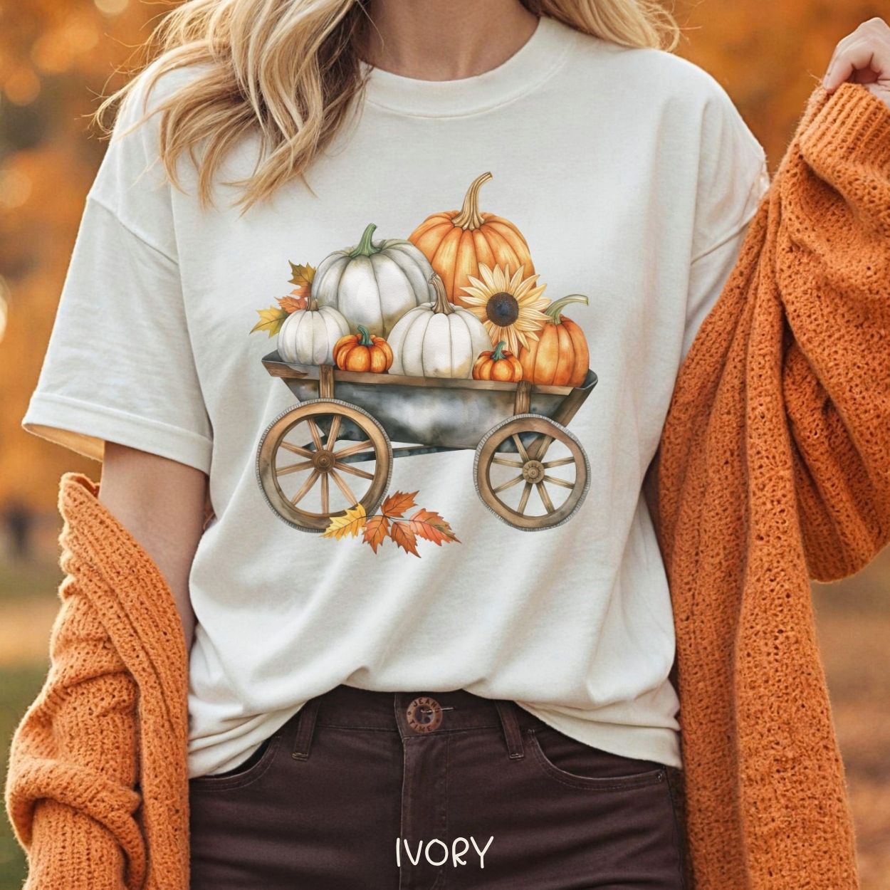Ivory relaxed-fit t-shirt with a rustic wagon full of watercolor pumpkins, sunflowers, and fall leaves.