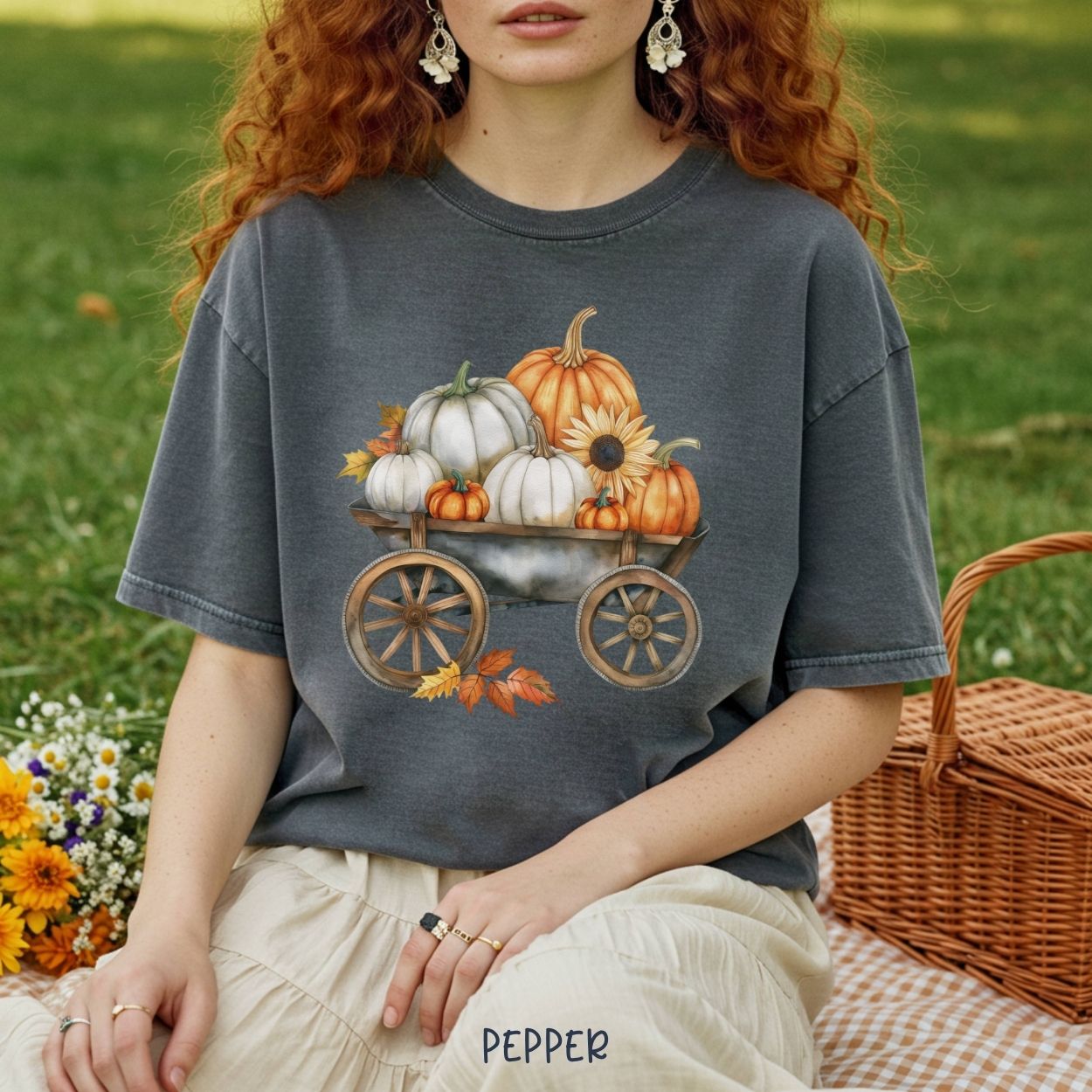 Garment-dyed pepper t-shirt with a rustic wagon of watercolor pumpkins, sunflowers, and fall leaves.
