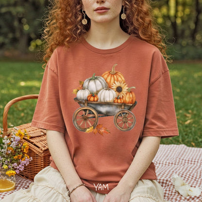 Garment-dyed rust t-shirt with a rustic wagon full of watercolor pumpkins, sunflowers, and autumn leaves.