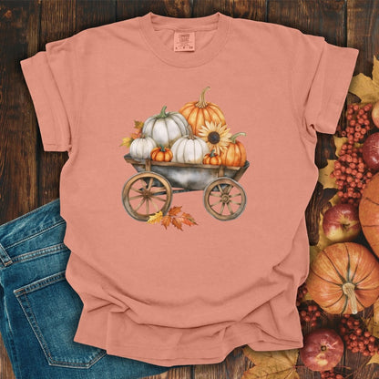 Terracotta S-size t-shirt with a rustic wagon of watercolor pumpkins, sunflowers, and autumn leaves.
