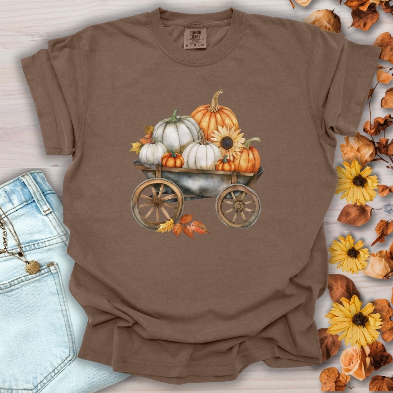 Espresso brown t-shirt with a watercolor rustic wagon filled with white and orange pumpkins and sunflowers.