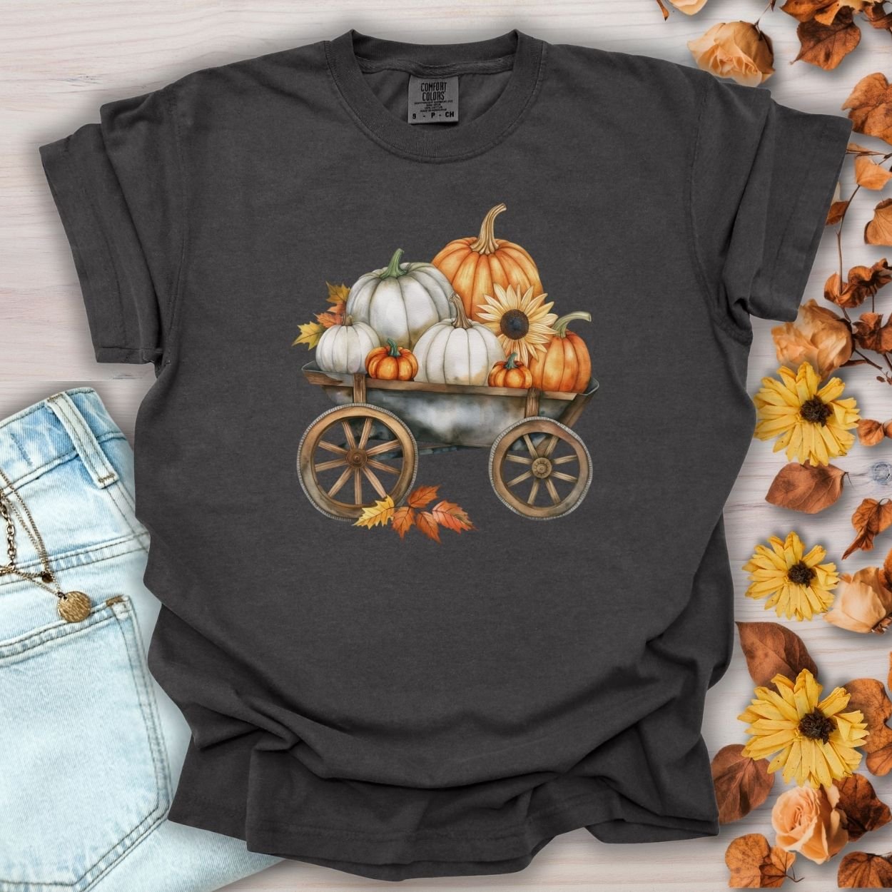 Pepper gray t-shirt with a watercolor rustic wagon full of white and orange pumpkins, sunflowers, and leaves.