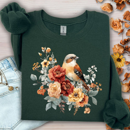 Forest Green Gildan S sweatshirt with watercolor sparrow and autumn roses, next to jeans.
