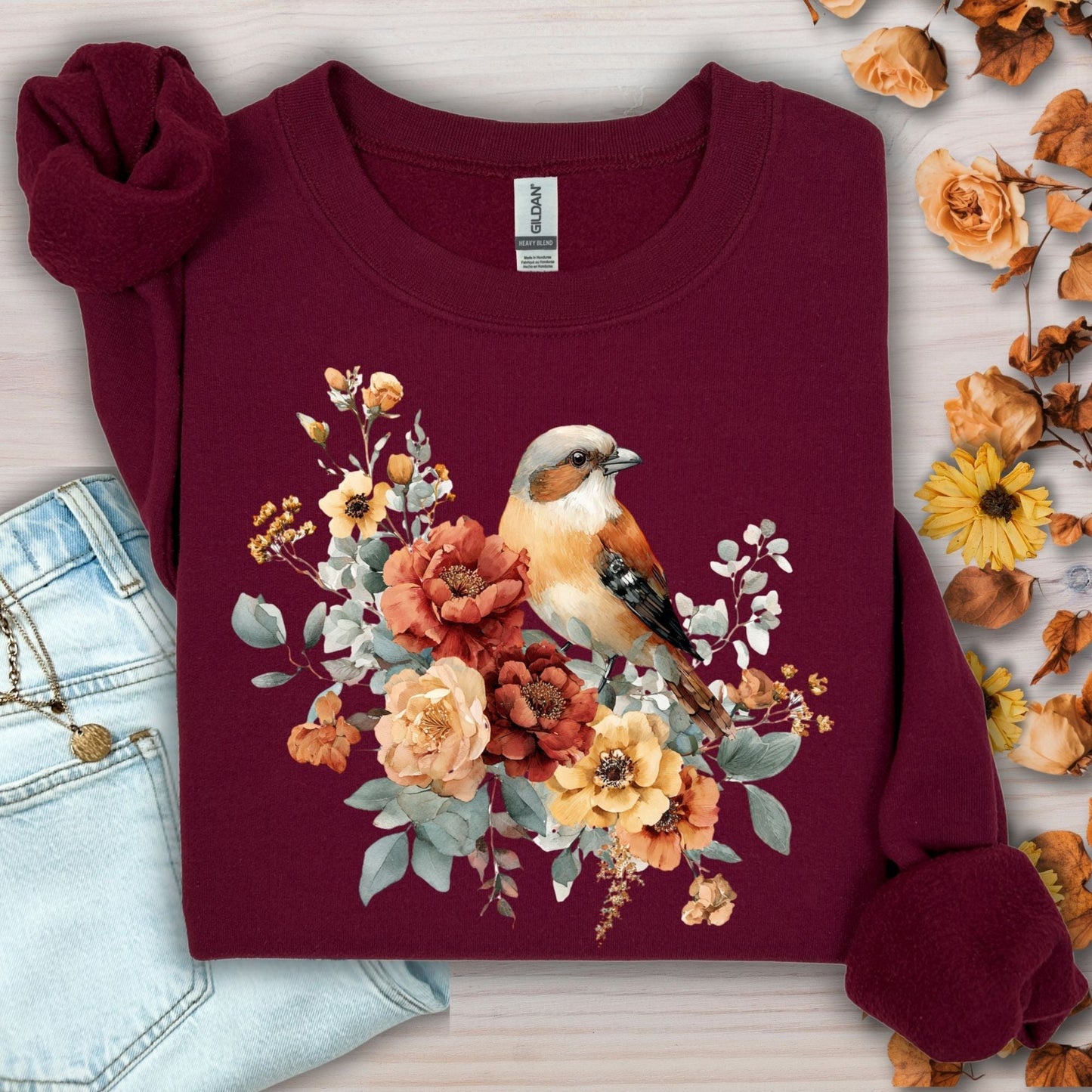 Maroon Gildan crewneck sweatshirt with a watercolor sparrow and autumn roses design.