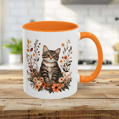 Autumn Striped Cat with Wildflowers 11oz ceramic mug, featuring a tabby kitten and burnt orange florals, with a golden yellow interior and handle.