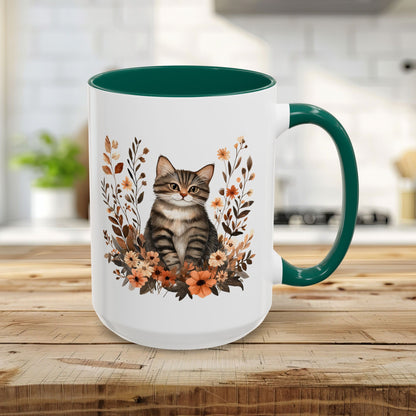 15oz glossy ceramic mug with a tabby cat, autumn wildflowers, and a green interior/handle.