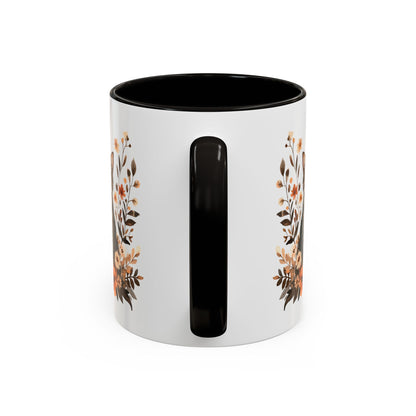 White ceramic mug with black handle and interior, featuring a watercolor autumn floral design.