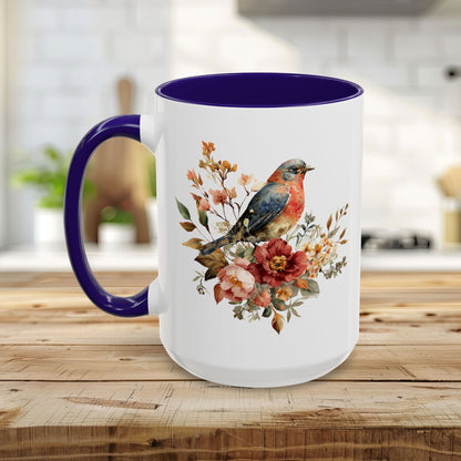 White ceramic mug with a bluebird and peony watercolor print, featuring a vivid purple interior and handle.