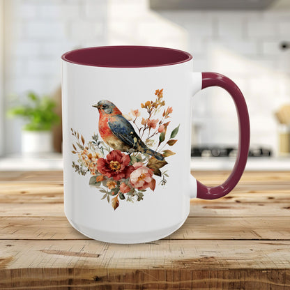 15oz white ceramic mug with maroon interior/handle, featuring a watercolor bluebird and peony design.