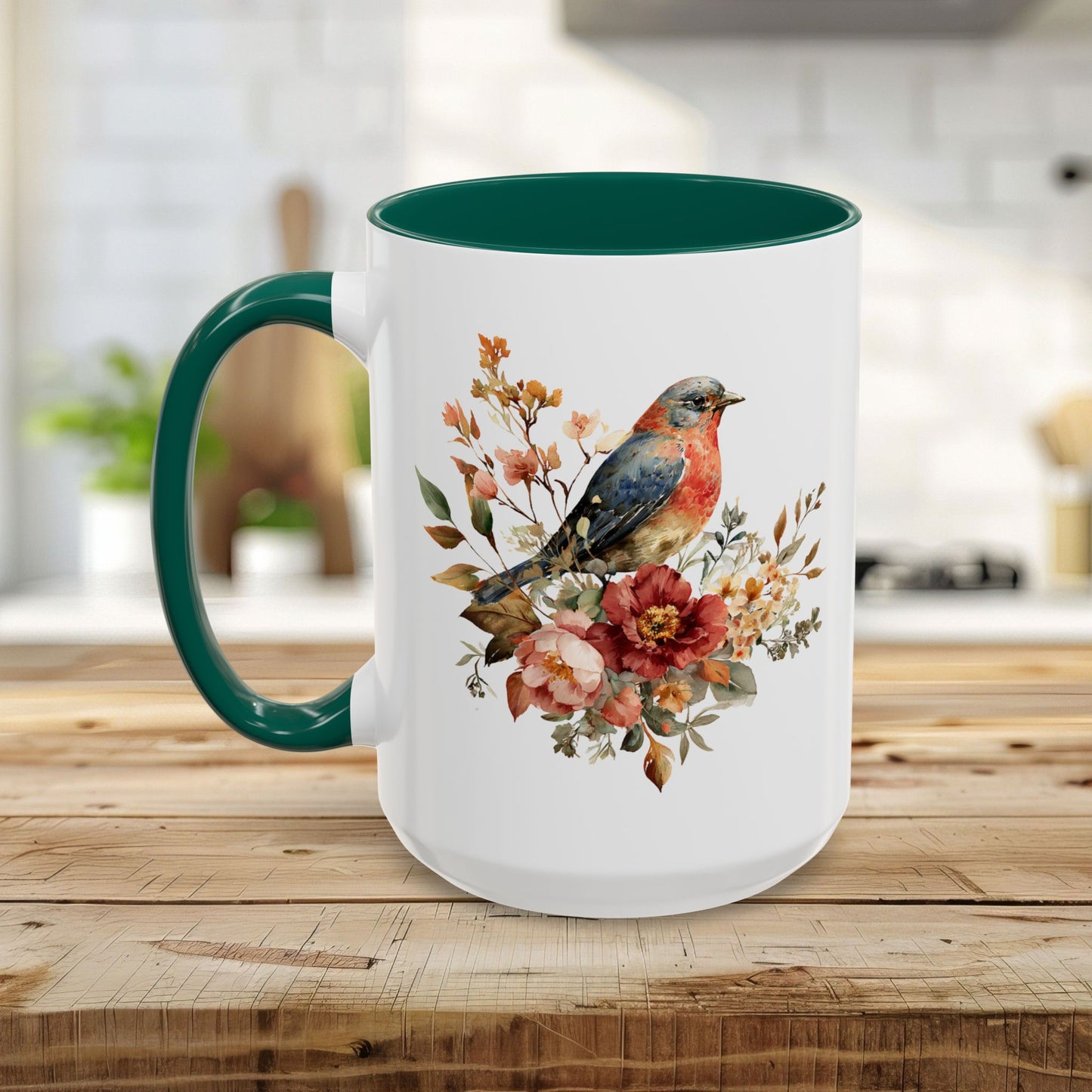 White ceramic mug with a green handle and interior, featuring a watercolor bluebird and peony floral design.