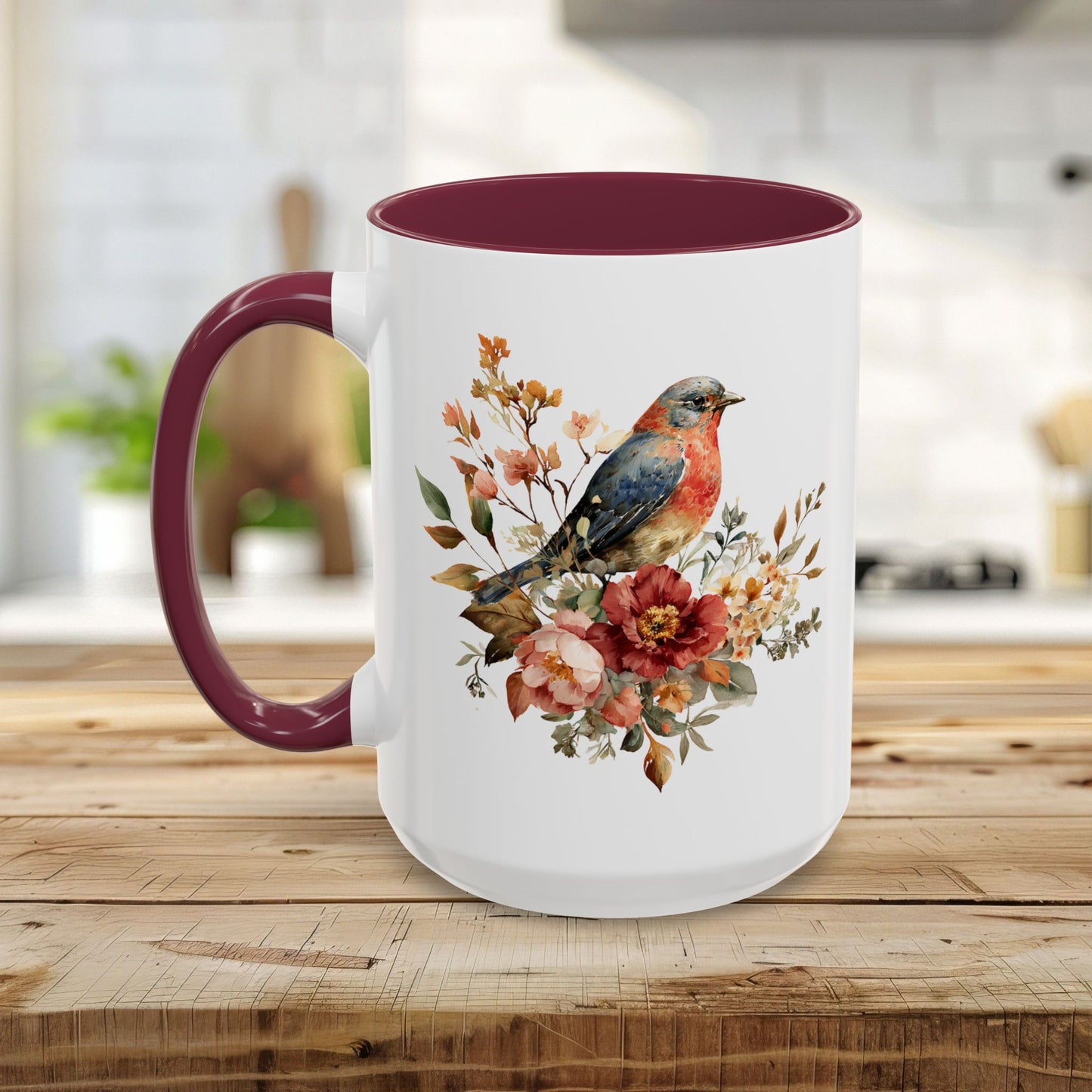 White ceramic mug with a watercolor bluebird and peony design, burgundy interior, and C-shaped handle.