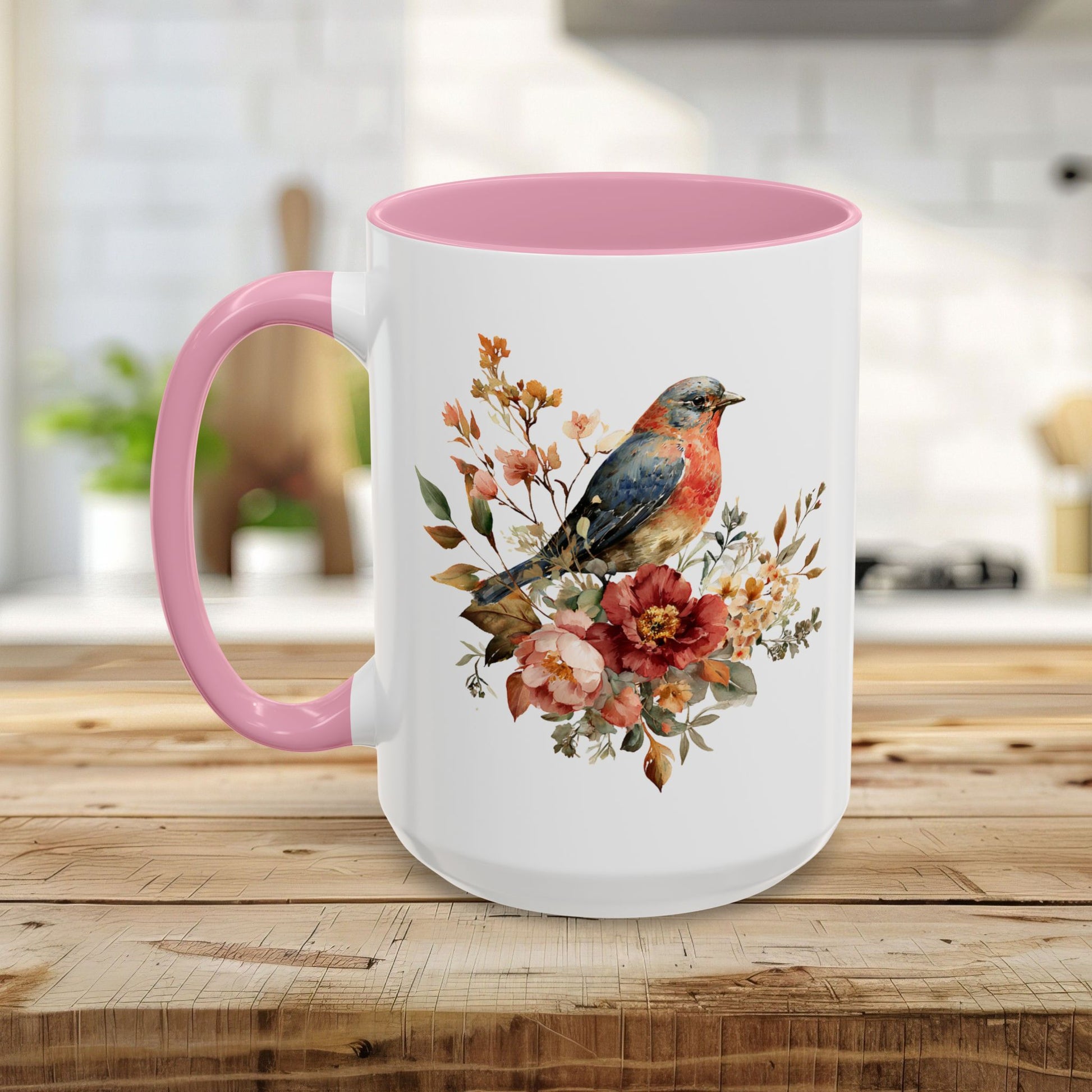 White ceramic mug with pink interior and handle, featuring a watercolor bluebird and peony floral design.