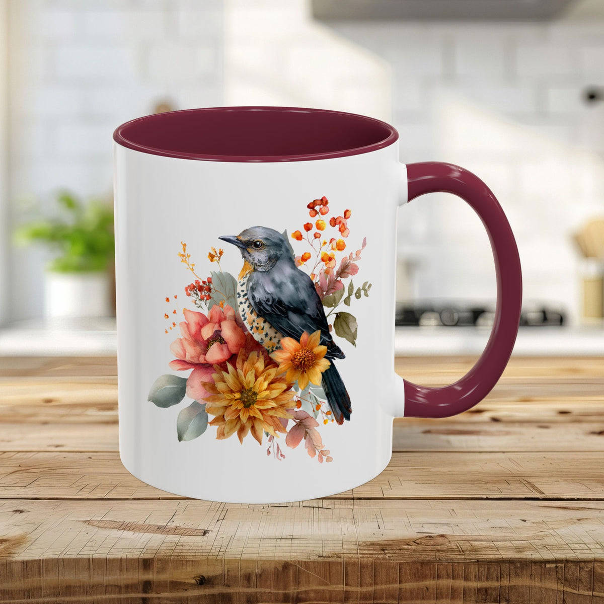 White ceramic 11oz mug with a maroon handle and interior, featuring a watercolor bluebird and autumn florals.