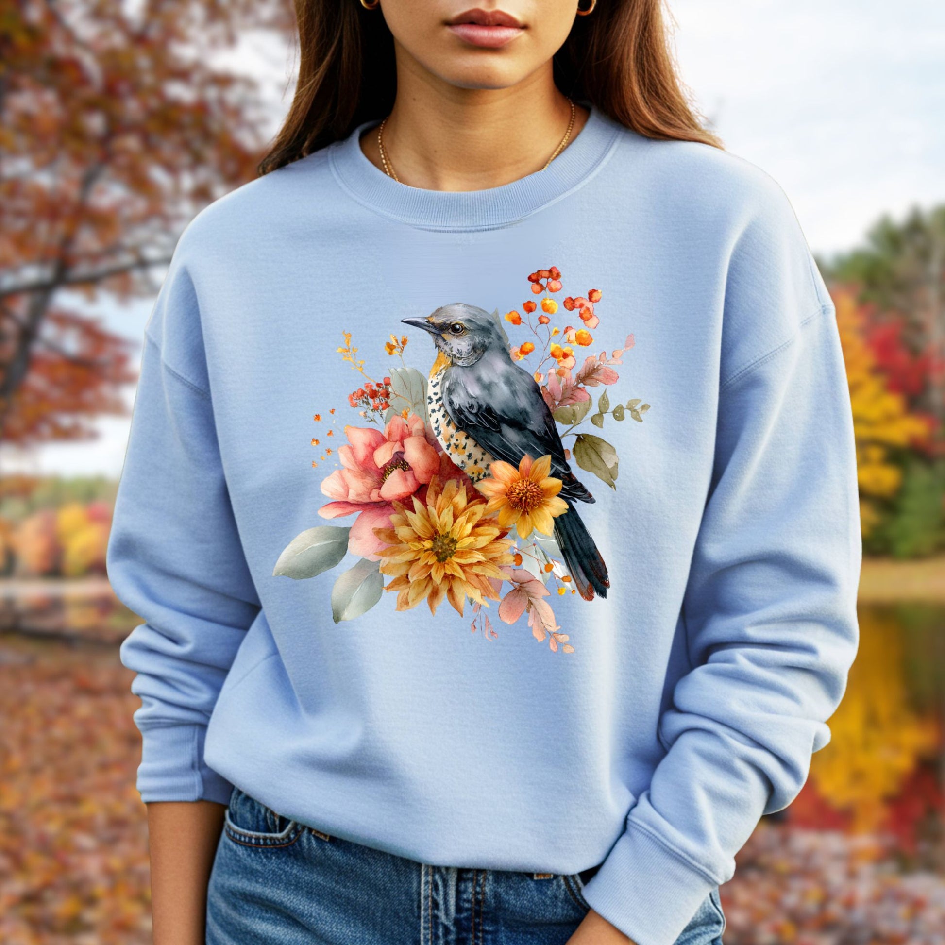 Autumn Vintage Meadow Bluebird Sweatshirt: Light blue crewneck with a painterly bird and floral design.