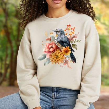 Cozy beige crewneck sweatshirt with a painterly bluebird and autumn floral design.