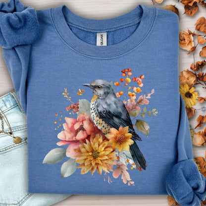 Indigo blue crewneck sweatshirt with a painterly bluebird and autumn floral design.