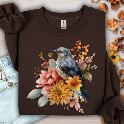 Dark chocolate crewneck sweatshirt with a painterly bluebird and autumn floral design.