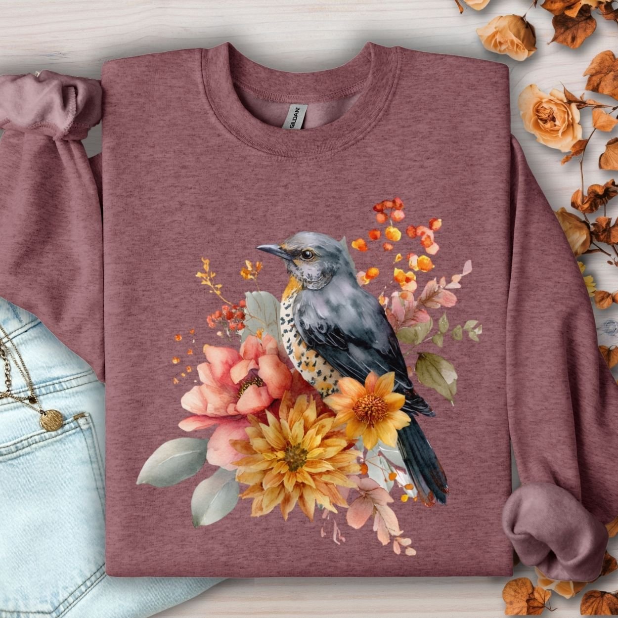 Heather Sport Dark Maroon crewneck sweatshirt with a watercolor bluebird and autumn floral design.