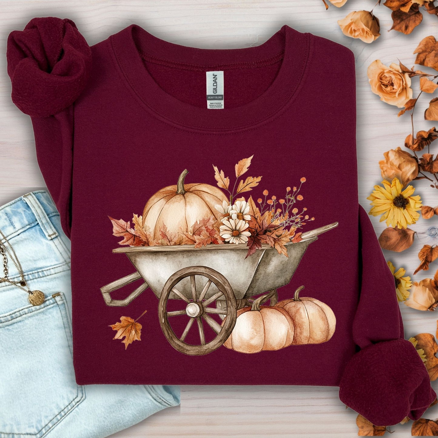 Maroon Gildan sweatshirt with a boho wagon, pumpkins, and autumn flowers design.