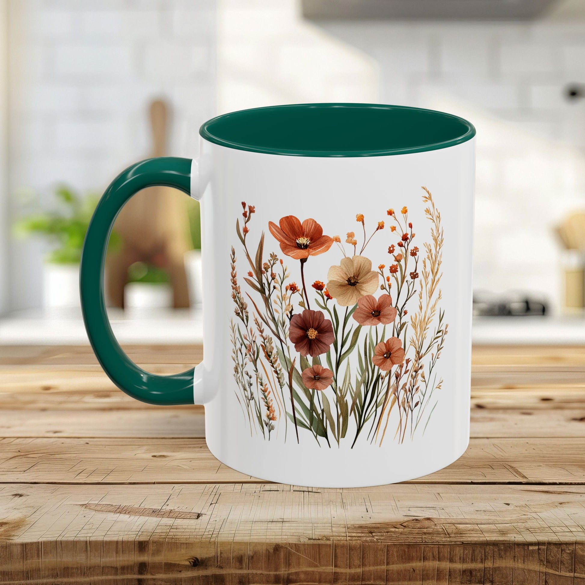 White ceramic mug with a dark green handle and interior, featuring watercolor autumn wildflowers.