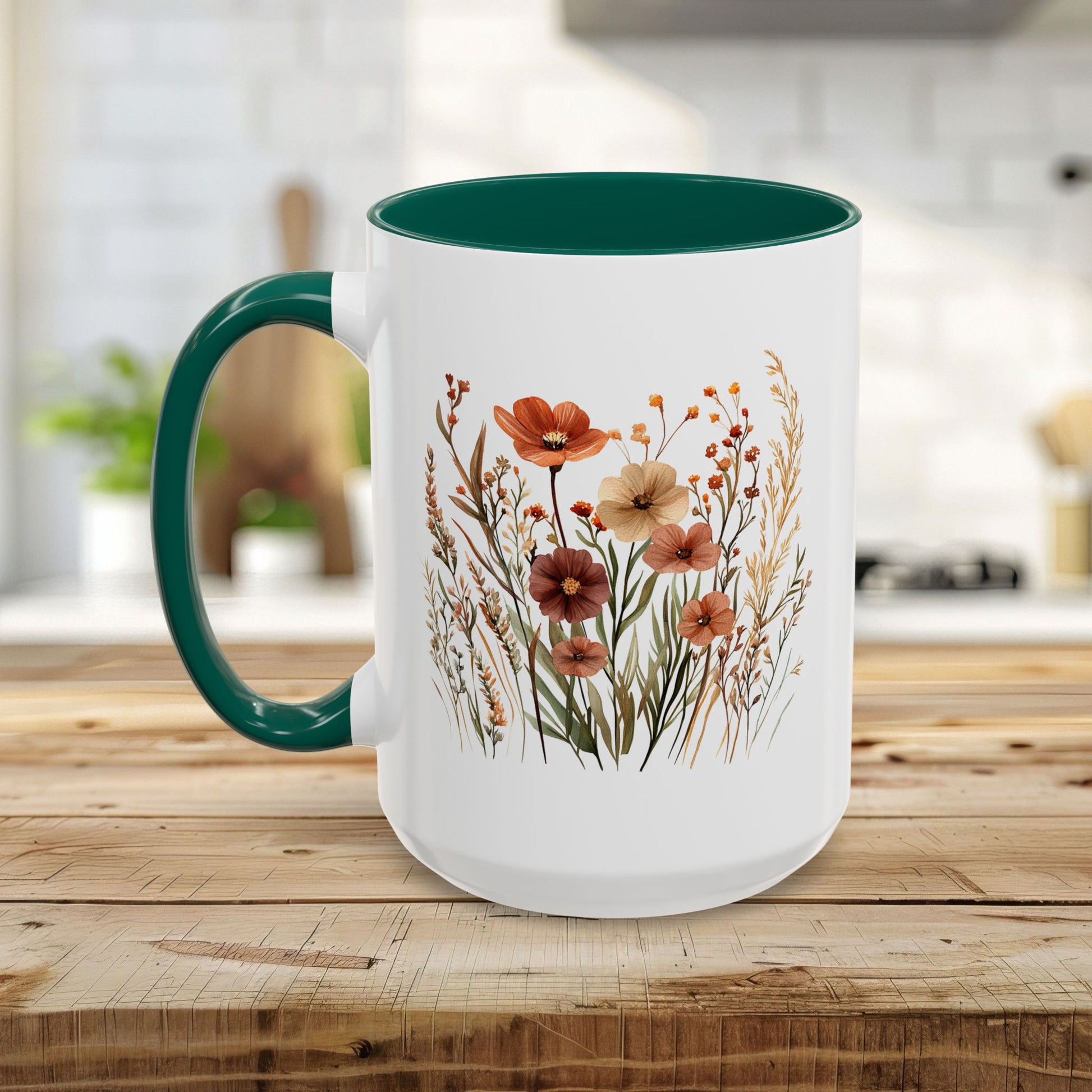 White ceramic mug with green handle and interior, featuring warm watercolor autumn wildflowers.