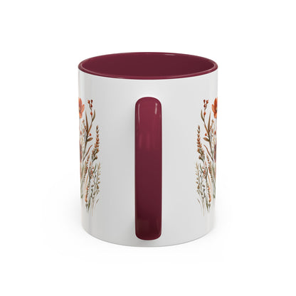 White ceramic mug with a burgundy handle and interior, featuring an autumn wildflower watercolor print.