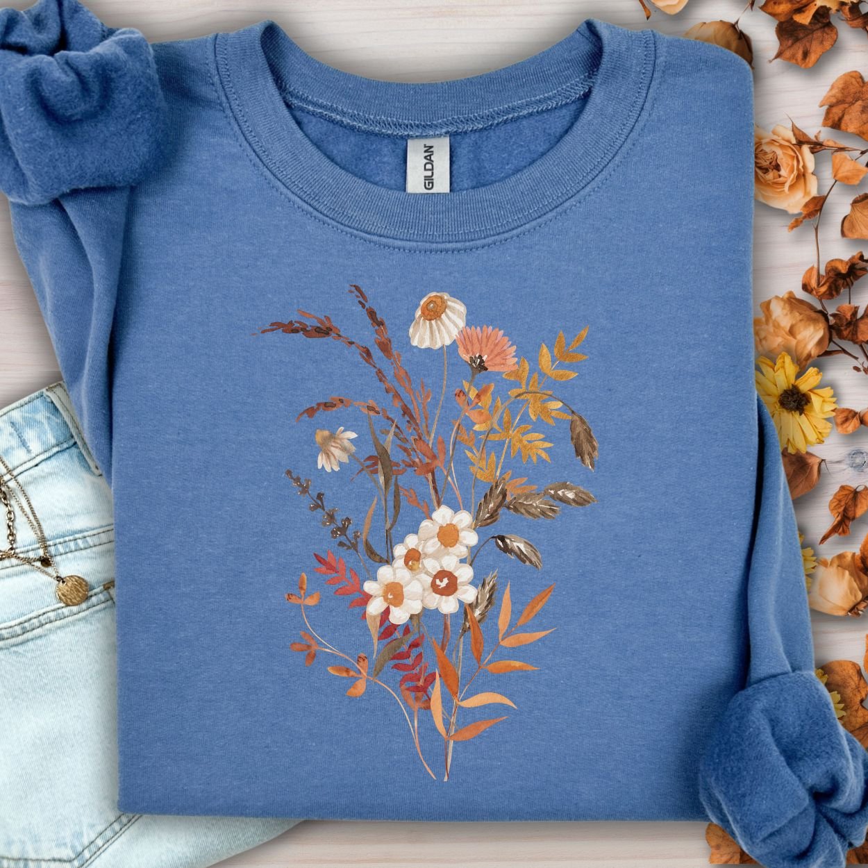 Indigo blue cotton-blend sweatshirt with a vintage autumn wildflower bouquet in warm beige and rust tones.