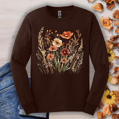 Dark chocolate long-sleeve tee with watercolor autumn wildflowers, surrounded by fall leaves and denim.