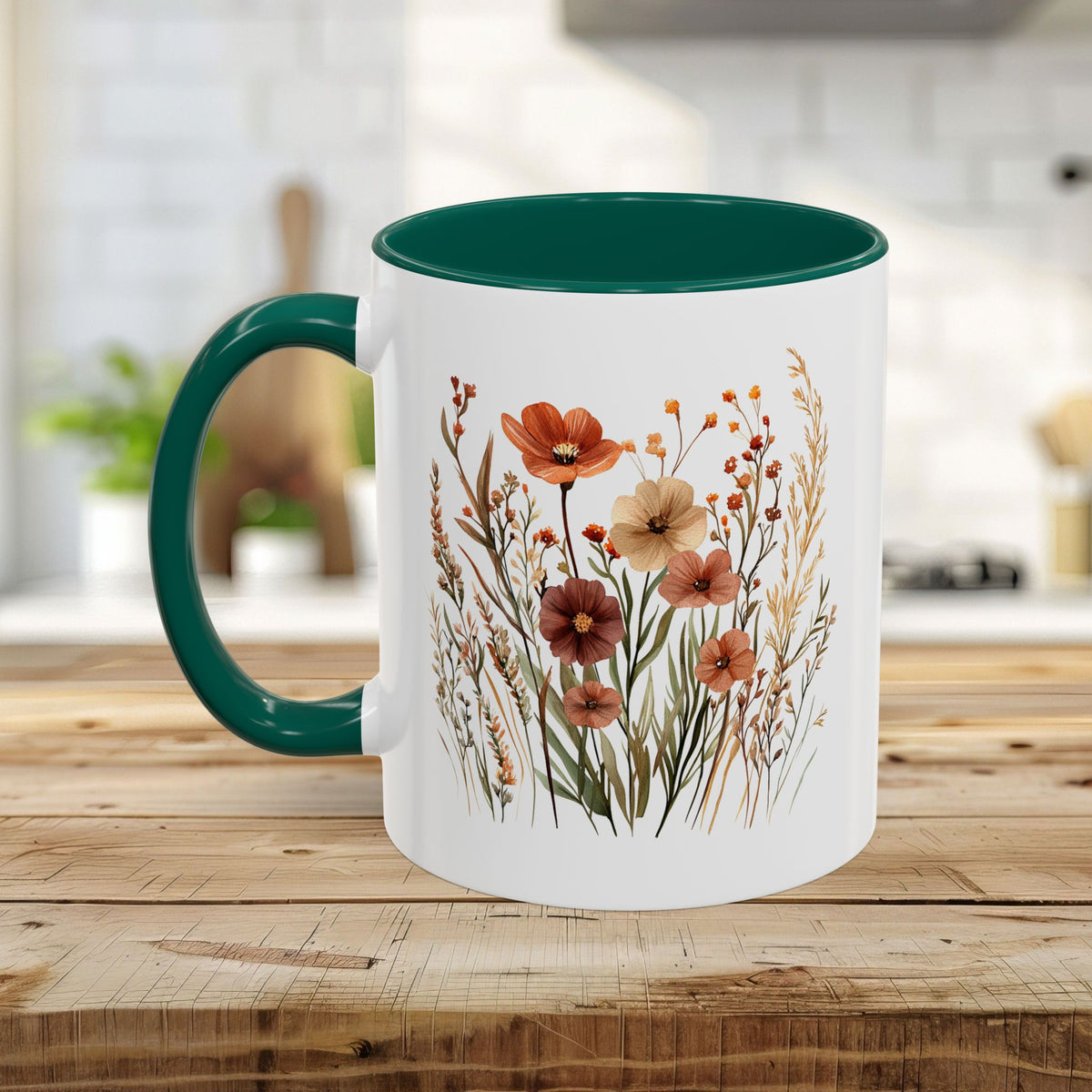 White ceramic mug with a dark green handle and interior, featuring watercolor autumn wildflowers.