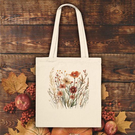 Natural cotton tote bag with an autumn wildflowers design, featuring red and orange blooms.