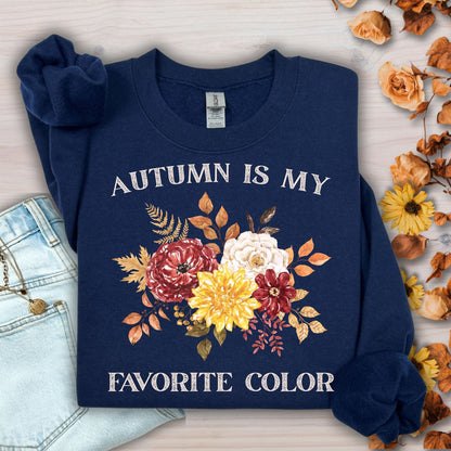 Navy 'Autumn Is My Favorite Color' sweatshirt with watercolor autumn flowers, next to jeans.