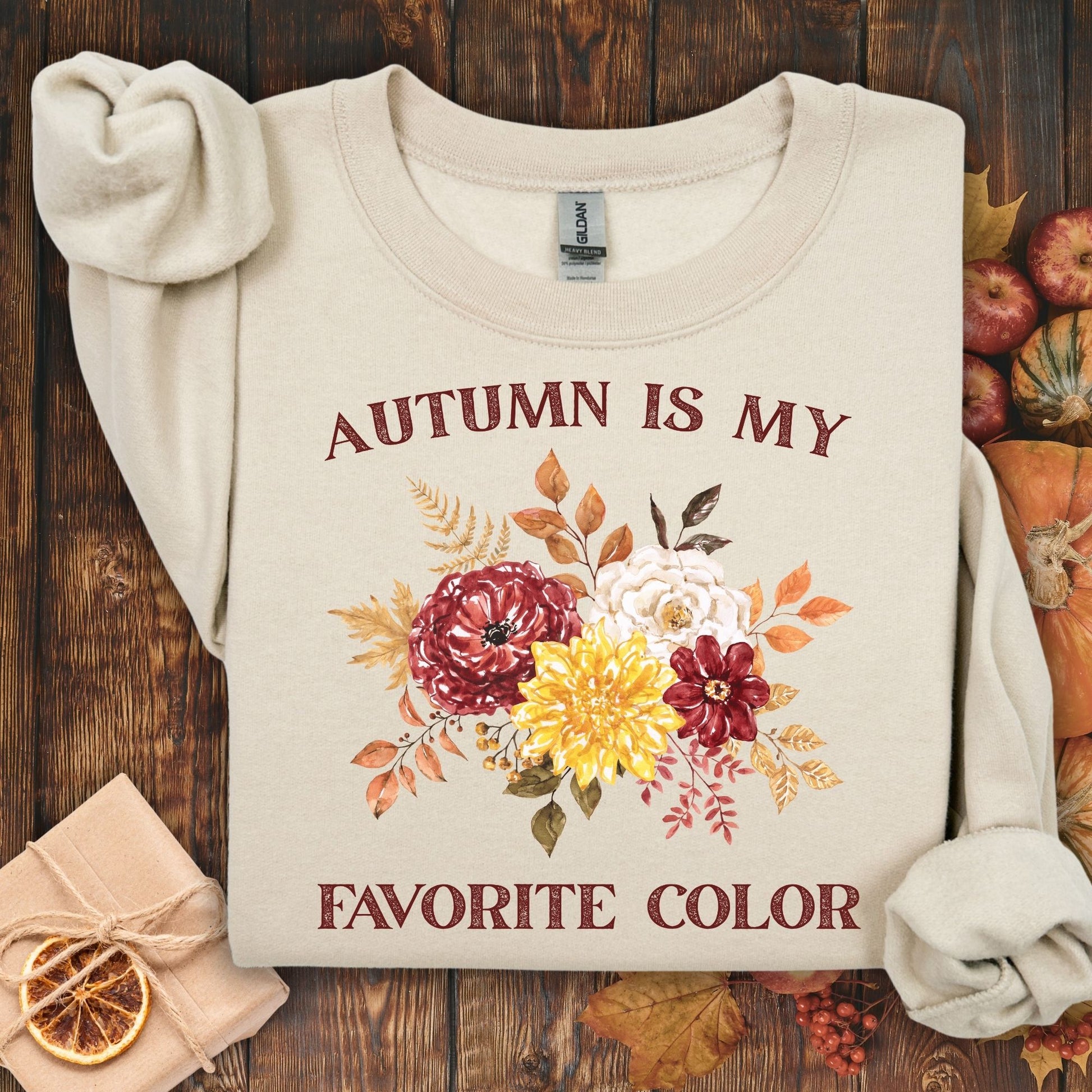 Sand 'Autumn is My Favorite Color' sweatshirt with watercolor autumn flowers, size S, on a wooden background.