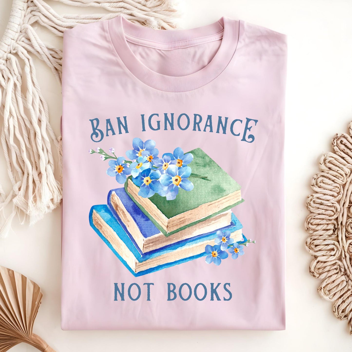Light pink S Ban Ignorance, Not Books t-shirt with vintage books and watercolor forget-me-nots.