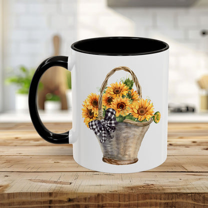 White ceramic mug with black handle and interior, featuring a watercolor basket of sunflowers and a gingham bow.