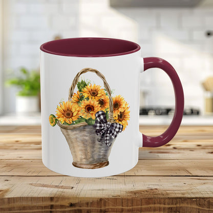 11oz ceramic mug with maroon trim, C-handle, and a watercolor basket of sunflowers with a gingham bow.