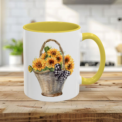 11oz ceramic mug with a yellow handle and interior, featuring a watercolor basket of sunflowers and a gingham bow.
