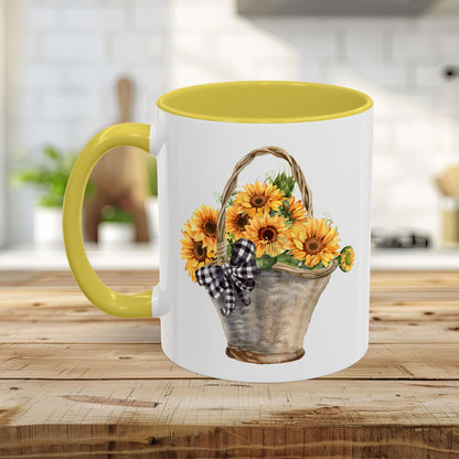 White ceramic mug with yellow interior and handle, featuring a watercolor basket of sunflowers and a gingham bow.