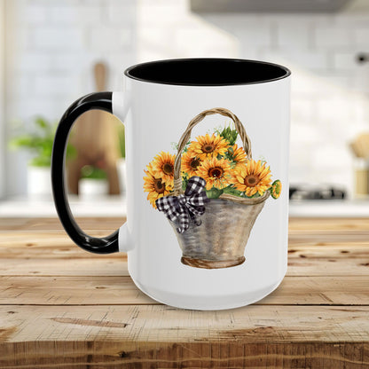 White ceramic mug with black handle and interior, featuring a watercolor basket of sunflowers and a gingham bow.