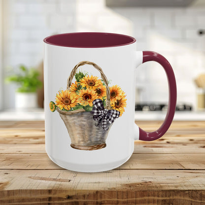 15oz white ceramic mug with maroon handle and interior, featuring a watercolor basket of sunflowers.