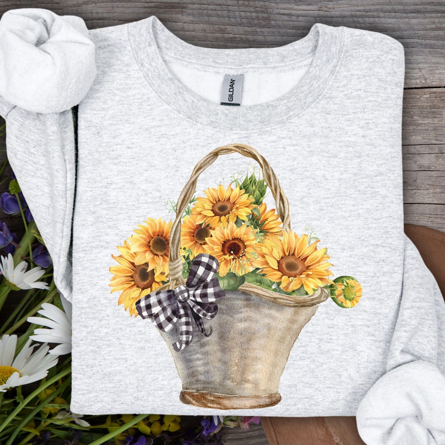 Ash gray Gildan sweatshirt with a watercolor basket of sunflowers and a black-and-white checkered bow.
